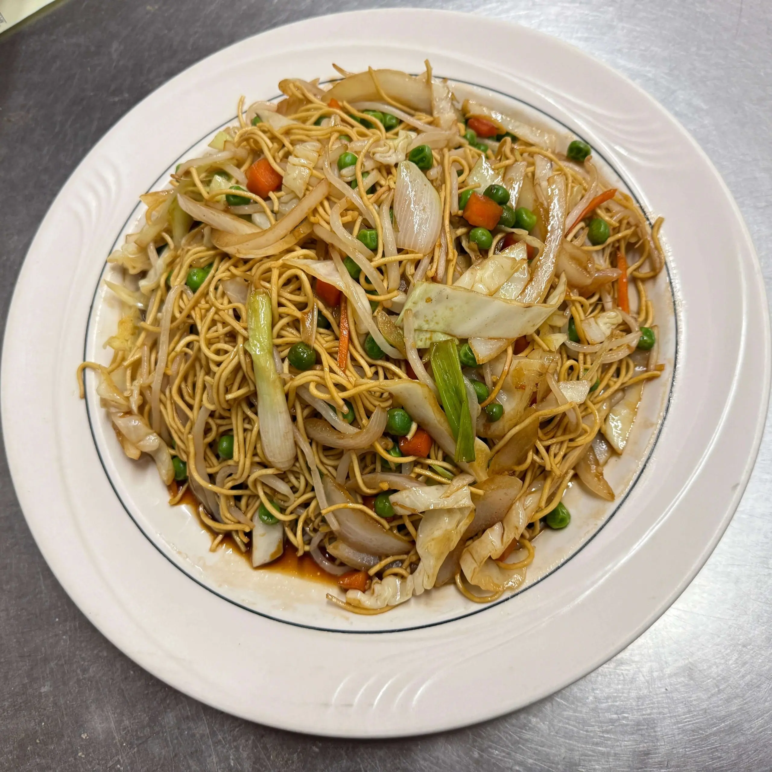 Vegetable chow mein with peas, carrots and cabbage on a white plate at Ocean Sky, a Chinese Restaurant in Chehalis