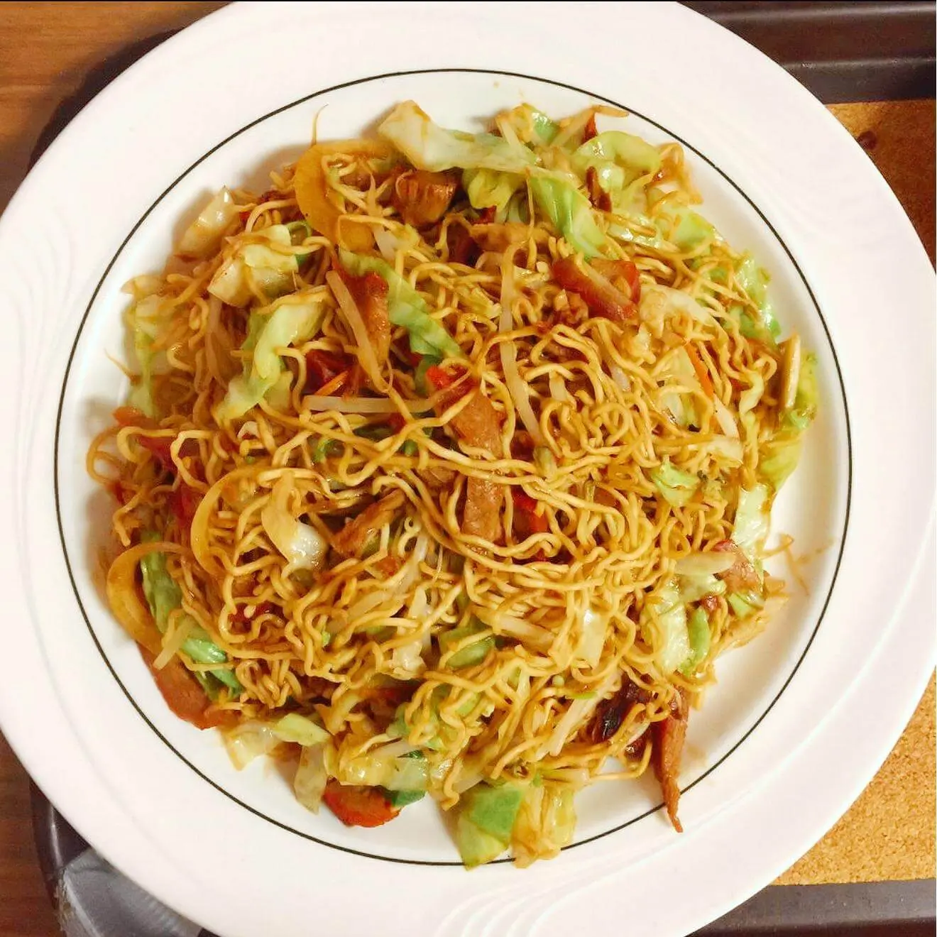 Pork and vegetable chow mein with cabbage on a white plate at Ocean Sky, a Chinese Restaurant in Chehalis