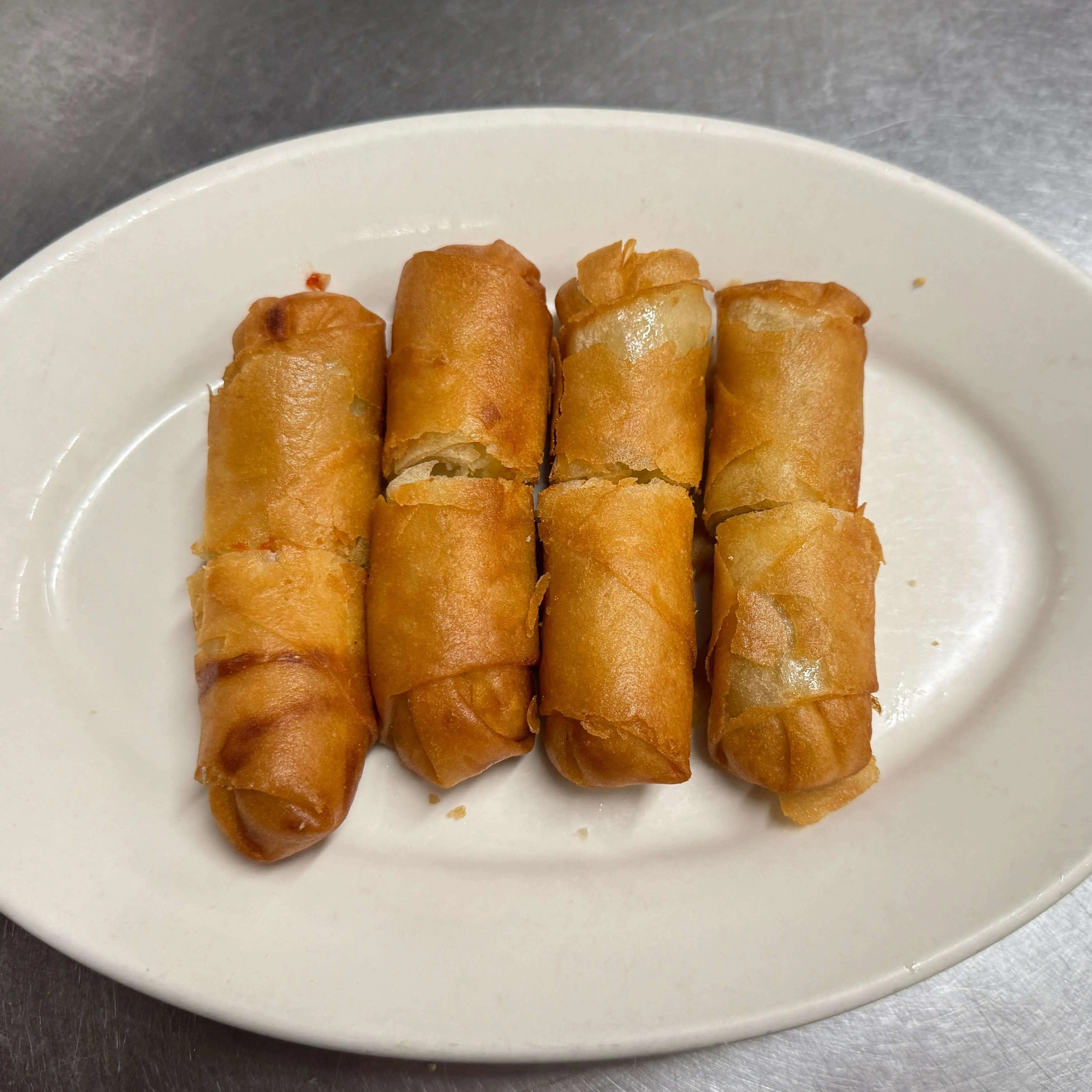 Crispy fried spring rolls served on a white plate at Ocean Sky, a Chinese Restaurant in Chehalis